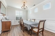 Elegant dining room in California with a wooden table covered by a gray cloth, surrounded by chairs