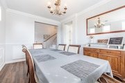 Elegant dining room with a long table, gray tablecloth, and cushioned chairs in California