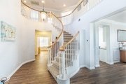 Elegant, curved staircase with white railings and wooden steps in California