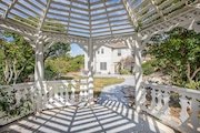 View from inside a white gazebo in California casting striped shadows on the ground.