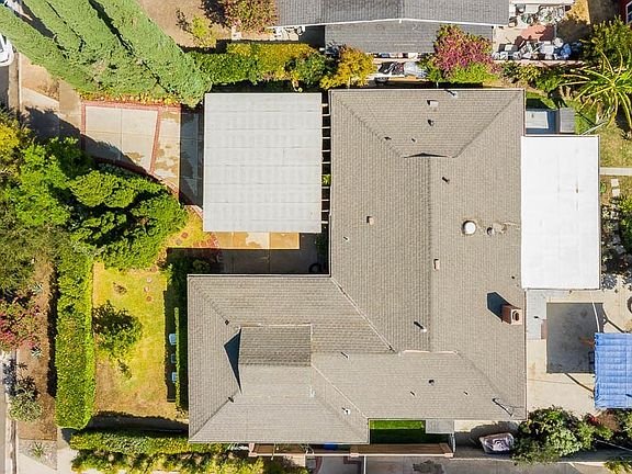Aerial view of a large residential property with a gray roof in California