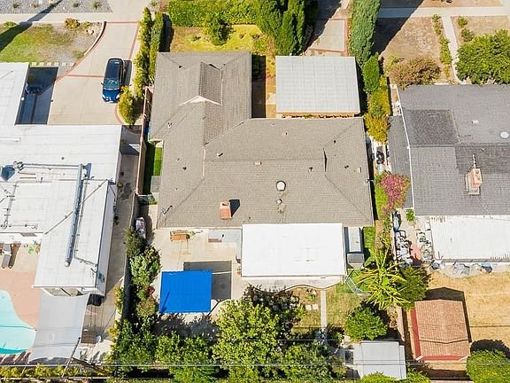 Aerial view of a neighborhood with gray-roofed house in California.