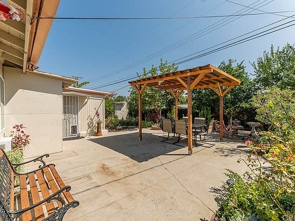Backyard with outdoor seating on a concrete patio in California.