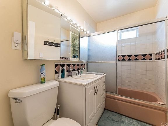 bathroom in California with a white vanity, sink and mirror
