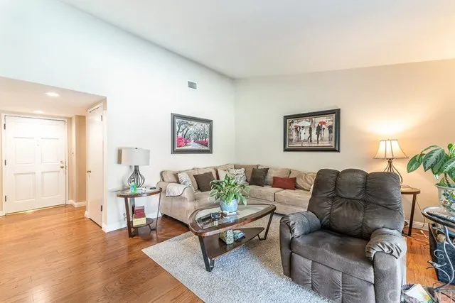 Living room with sofa, recliner, and a glass coffee table in California.