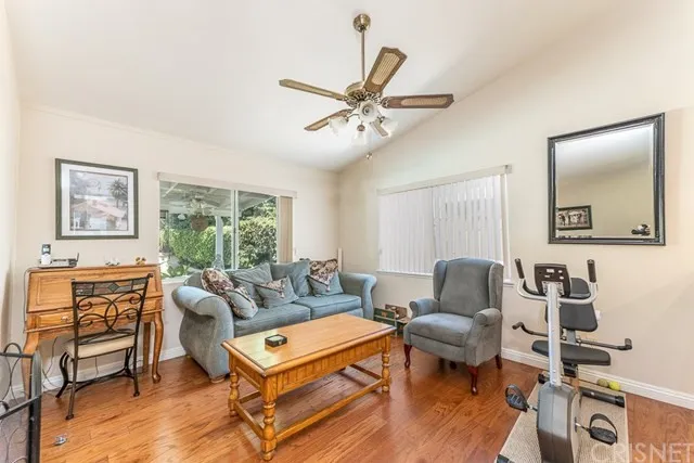 Living room in California with a blue sofa, gray armchair, and wooden coffee table.