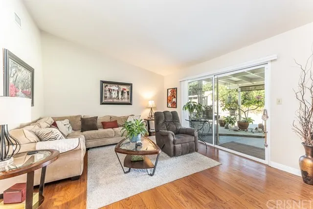 Living room with sofa, recliner, and glass coffee table in California