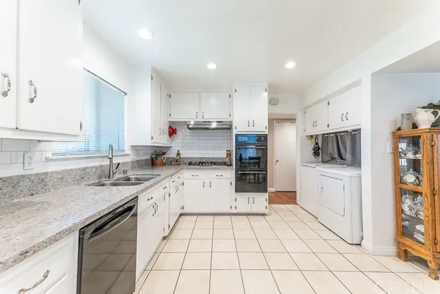 Kitchen in California with white cabinets, countertops and stainless-steel appliances