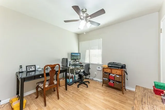Home office in California with a ceiling fan with a desk, chair and computer.