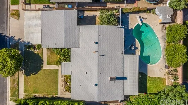 Aerial view of a property in California with a grey-roofed house with swimming pool.