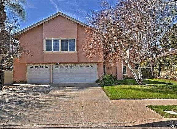 Two-story house in California with garage and large windows.